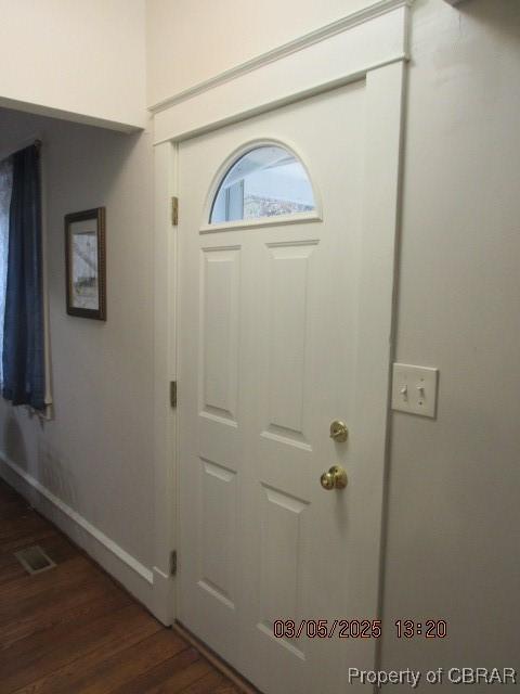 entryway with dark wood-style flooring and visible vents