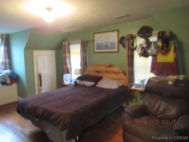 bedroom with lofted ceiling