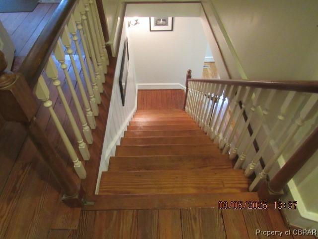 stairway with wood finished floors