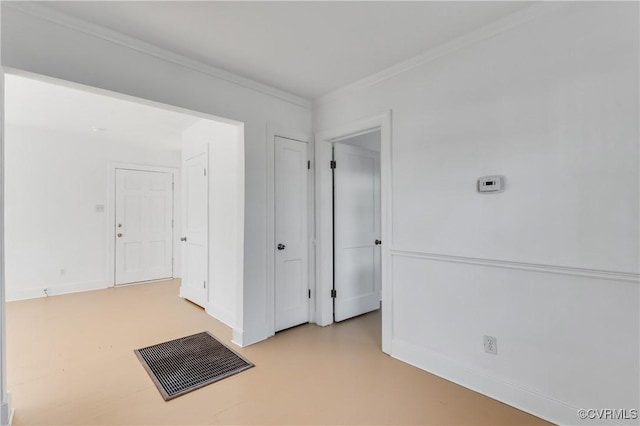 unfurnished room with ornamental molding, concrete flooring, and baseboards