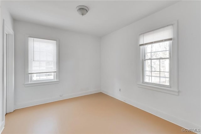 unfurnished room featuring baseboards