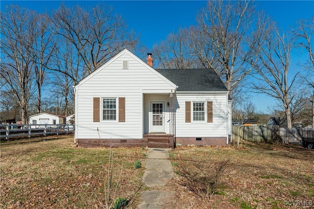 bungalow with a chimney, a shingled roof, crawl space, fence, and a front lawn