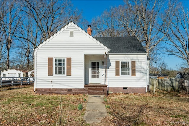 bungalow-style home with a front lawn, crawl space, a chimney, and fence