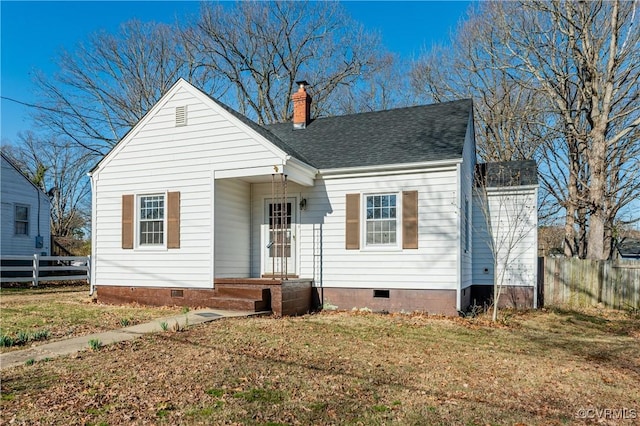 view of front of house with a front yard, crawl space, fence, and a chimney