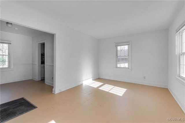 unfurnished room with visible vents