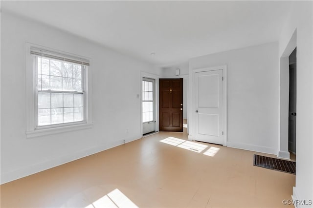 unfurnished room featuring a healthy amount of sunlight