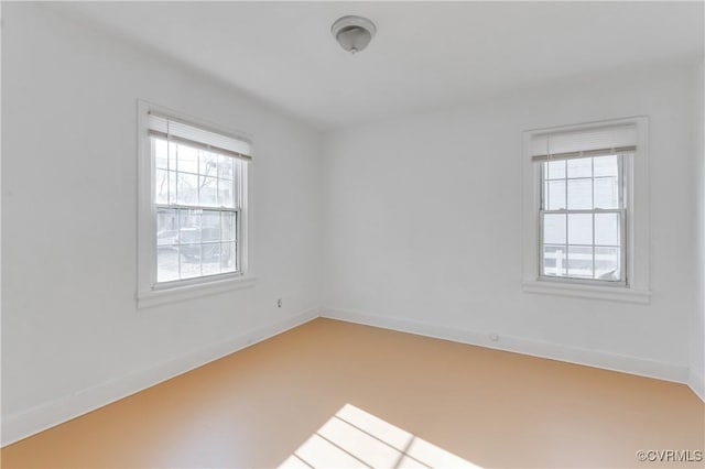 spare room featuring baseboards