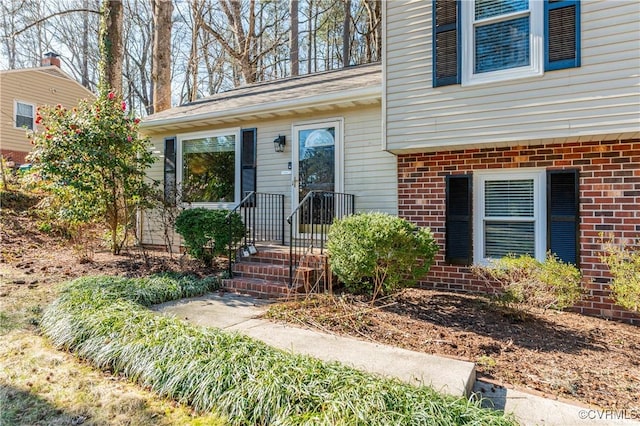 property entrance with brick siding