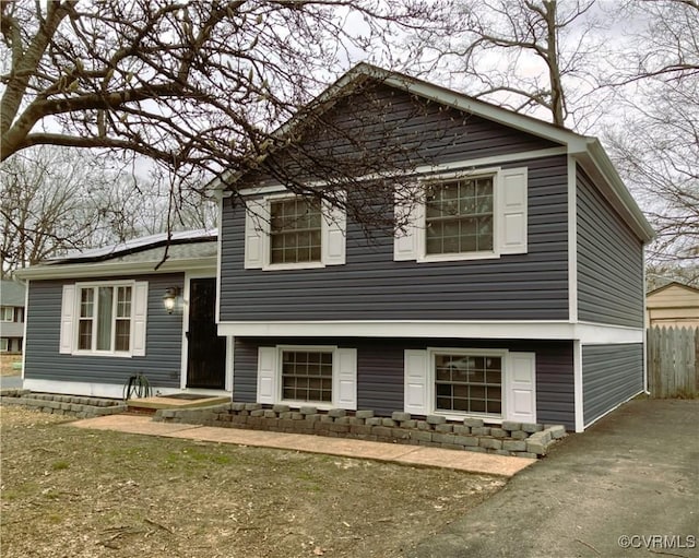 tri-level home featuring fence