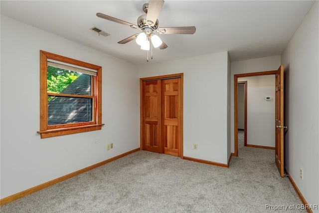 unfurnished bedroom with light carpet, ceiling fan, visible vents, and baseboards