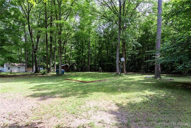 view of yard featuring a forest view