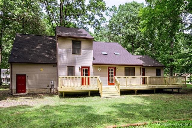 exterior space featuring roof with shingles, a deck, and a yard
