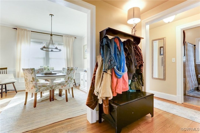 mudroom featuring a notable chandelier, baseboards, and hardwood / wood-style floors