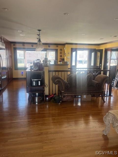 interior space featuring ornamental molding and dark wood finished floors