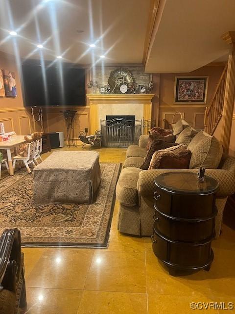 home theater room featuring a wainscoted wall, a fireplace, and a decorative wall