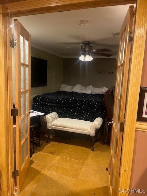 bedroom with a ceiling fan and crown molding