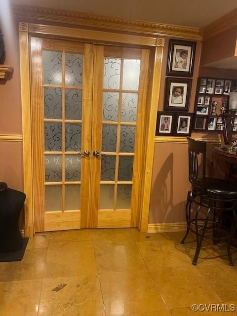 doorway to outside with crown molding and french doors