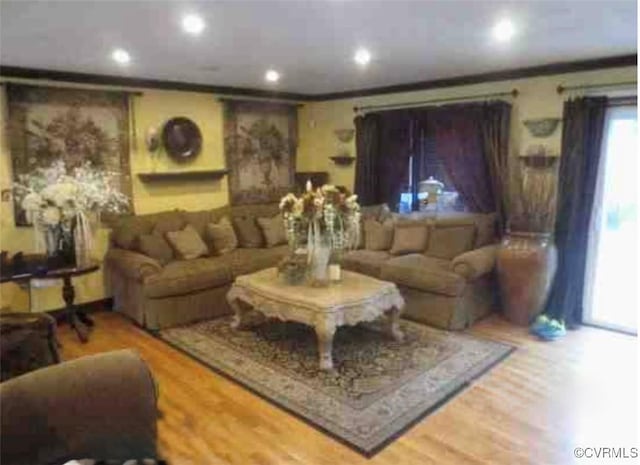 living room with ornamental molding, wood finished floors, and recessed lighting