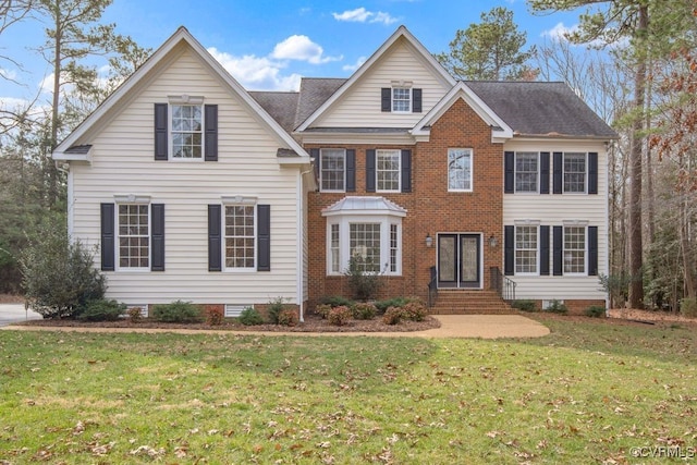 view of front of home with brick siding, roof with shingles, entry steps, crawl space, and a front yard