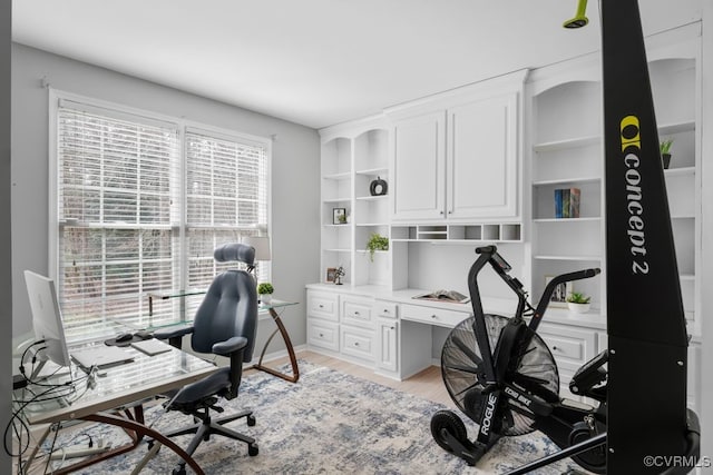 office area with light wood finished floors and baseboards