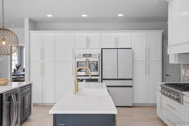 kitchen with beverage cooler, light countertops, appliances with stainless steel finishes, and white cabinets