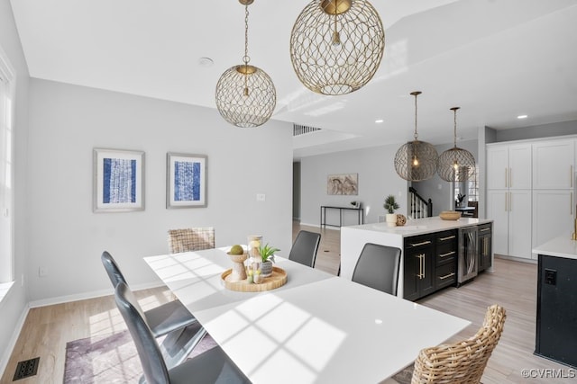 dining room with wine cooler, light wood-style flooring, recessed lighting, visible vents, and baseboards