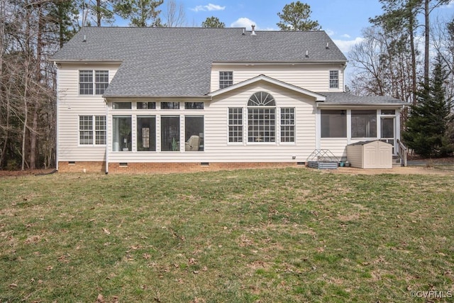 back of property with a lawn, a shingled roof, crawl space, and a sunroom