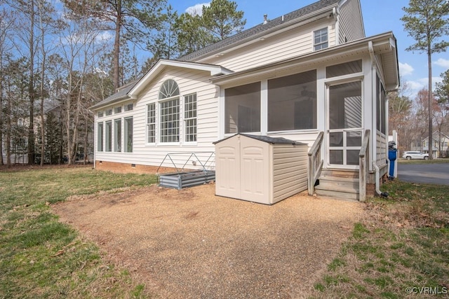 rear view of house with a sunroom, crawl space, and a lawn