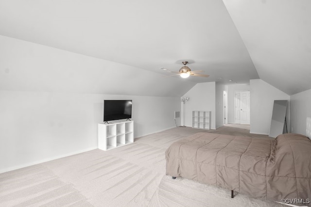 carpeted bedroom featuring lofted ceiling and a ceiling fan