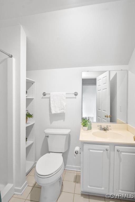 full bathroom featuring toilet, tile patterned flooring, a shower, and vanity