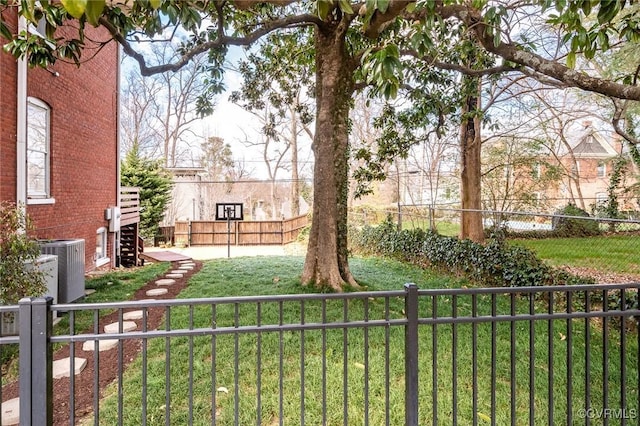 view of yard featuring fence private yard, cooling unit, and stairs