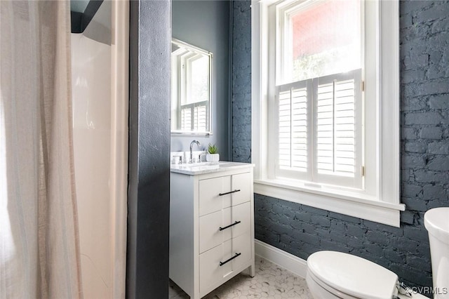 full bathroom with marble finish floor, baseboards, vanity, and toilet