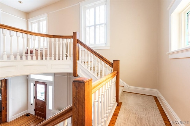 stairs featuring a wealth of natural light and baseboards