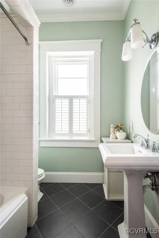 bathroom featuring crown molding, baseboards, toilet, and tile patterned floors