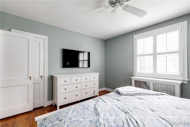 bedroom featuring a ceiling fan, wood finished floors, and baseboards