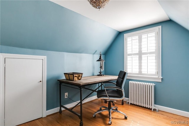 office with vaulted ceiling, radiator heating unit, wood finished floors, and baseboards