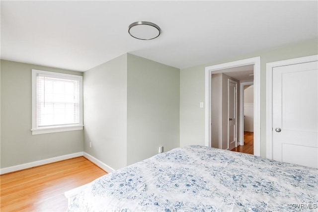 bedroom with wood finished floors and baseboards