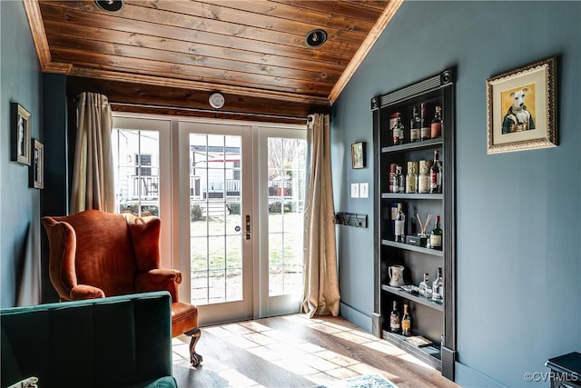 doorway to outside with built in shelves, french doors, crown molding, wood ceiling, and vaulted ceiling