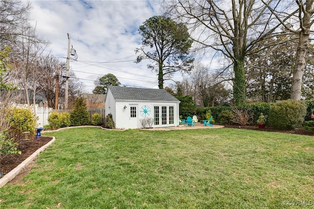 view of yard with french doors, a patio area, an outdoor structure, and fence