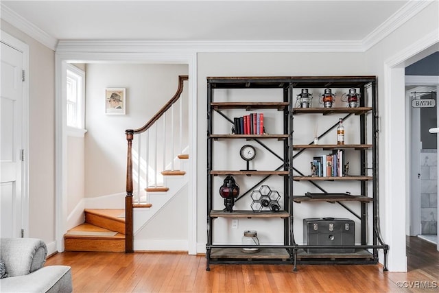 room details with baseboards, wood finished floors, and crown molding