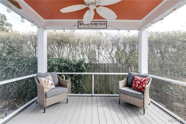 sunroom / solarium featuring a wealth of natural light and ceiling fan