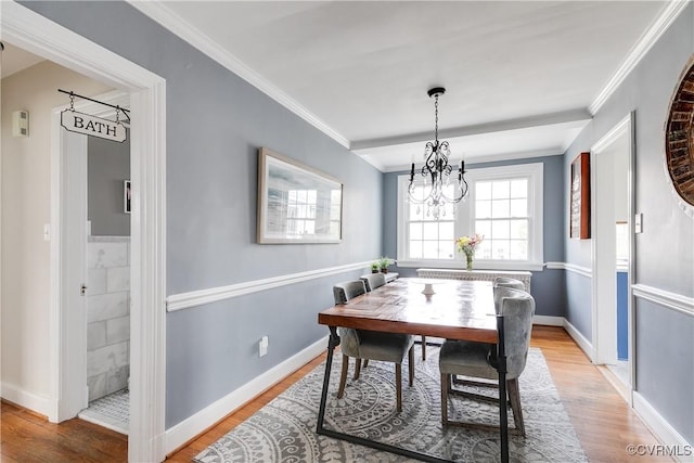 dining area with light wood-style flooring, baseboards, and ornamental molding