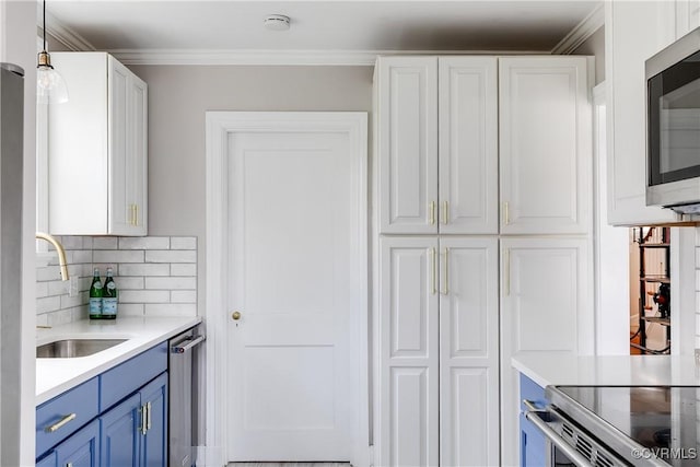 kitchen featuring white cabinets, appliances with stainless steel finishes, blue cabinets, and a sink