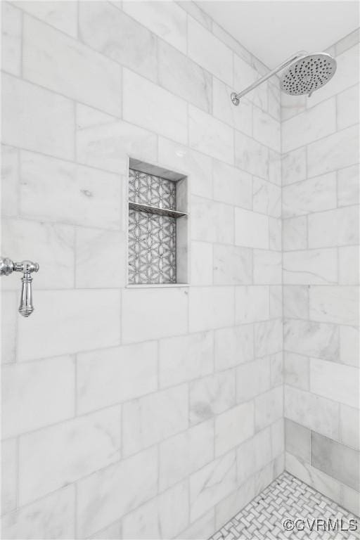 bathroom with a tile shower