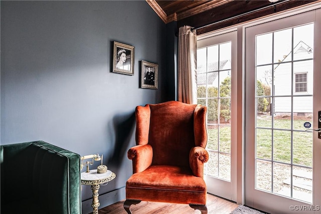 sitting room with plenty of natural light and wood finished floors