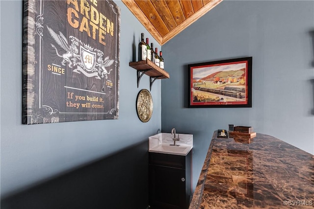 bathroom featuring a sink, wood ceiling, and vaulted ceiling