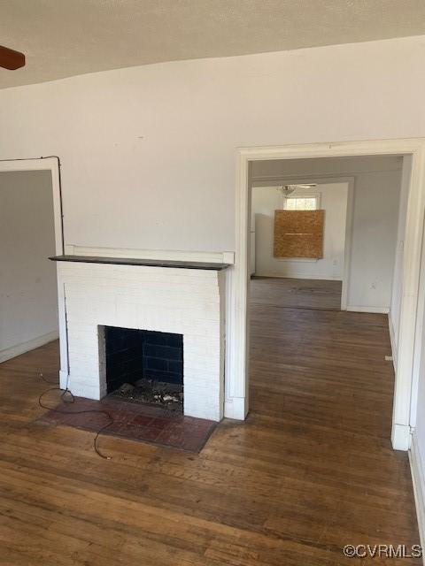 interior details with a fireplace with flush hearth and wood finished floors