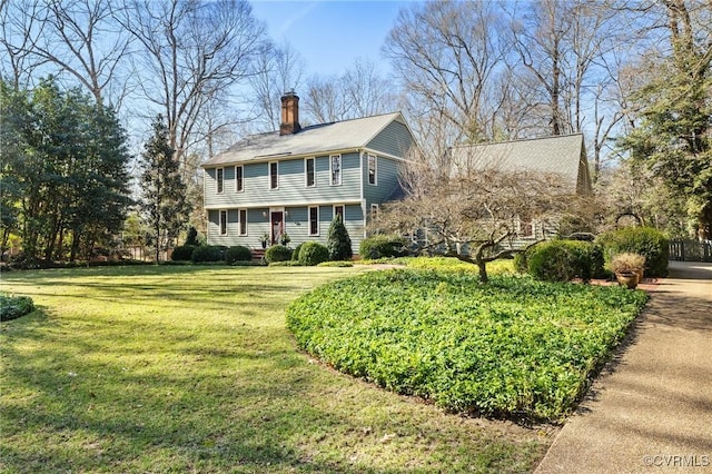 colonial house with a chimney and a front lawn