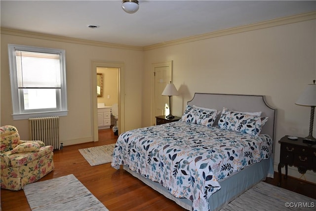 bedroom featuring connected bathroom, wood finished floors, baseboards, radiator, and crown molding