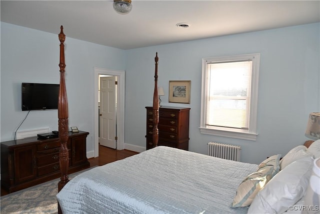 bedroom featuring radiator, baseboards, and visible vents